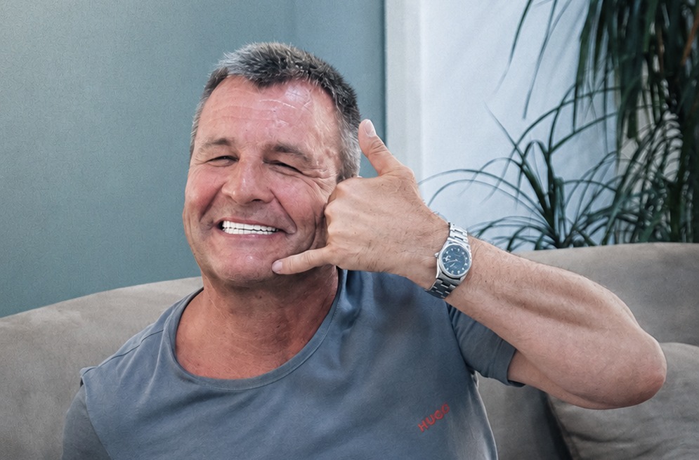 Happy patient showing his new smile after treatment at Dentafly London